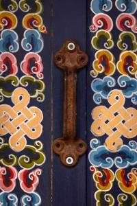 a wooden door with a handle with colorful designs on it at Family-Friendly Yurt for Stargazing near Joshua Tree National Park, California in Sunfair Heights +1 photo