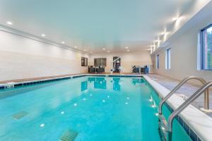 a swimming pool with blue water in a building at Hampton Inn Akron-South in Akron