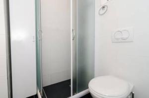 a bathroom with a toilet and a glass shower at Apartment Sara in Dubrovnik