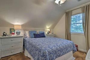 a bedroom with a bed and a dresser and a window at Delightful Waterfront Cabin Rental Overlooking Lake Martin, Elmore County, Alabama in Equality