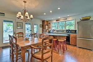 a large kitchen with a wooden table and chairs at Delightful Waterfront Cabin Rental Overlooking Lake Martin, Elmore County, Alabama in Equality