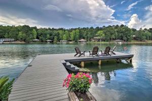 a dock with chairs and flowers on a lake at Delightful Waterfront Cabin Rental Overlooking Lake Martin, Elmore County, Alabama in Equality