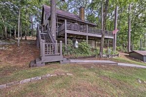 a large house with a staircase in the woods at Delightful Waterfront Cabin Rental Overlooking Lake Martin, Elmore County, Alabama in Equality