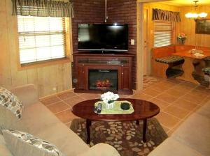 a living room with a couch and a fireplace at Picturesque Cabin Incredible for a Holiday Escape in Inverness, Florida in Inverness +6 photos