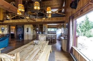 a dining room and kitchen with a large wooden table at Scenic Cabin with Wildlife Views Near Madison River, Ennis, Montana in Ennis