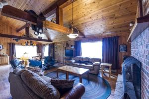 a living room with a couch and a table at Scenic Cabin with Wildlife Views Near Madison River, Ennis, Montana in Ennis