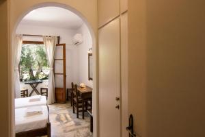 a room with an archway leading to a bedroom at Naftilos Skiathos in Skiathos