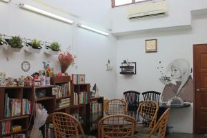 a room with a table and chairs and a book shelf at Project Uchi SS2 in Petaling Jaya