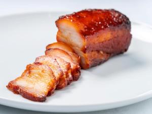 a piece of meat on a white plate at TRANSCENDER HOTEL Yokohama in Yokohama