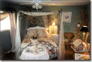 a bedroom with a canopy bed with a table at Peaceful Cabin Getaway Overlooking Tuscarawas River Valley in New Philadelphia, Ohio in New Philadelphia