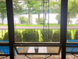 a view from a window of a table with a cup at Peaceful Private Cabin on Crystal Lake near Elk Mountain, Pennsylvania in Dundaff