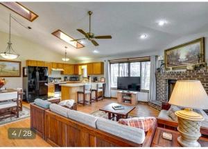 a living room with a couch and a fireplace at Charming Cabin on Golf Course with Fireplace & Resort Perks in Hedgesville, West Virginia in Baxter