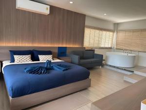 a bedroom with a bed and a bath room with a tub at Calm Kamala Phuket in Kamala Beach +180 photos