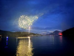 a firework display over a body of water at night at Enchanting Cabin with Breathtaking Sunset and Lake Views in North Carolina in Glenville