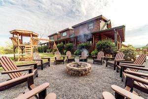 a yard with chairs and a fire pit in front of a house at Spectacular Cabin with Incredible Indoor and Outdoor Spaces in Tennessee in Large Island