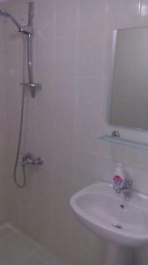 a bathroom with a sink and a shower with a mirror at Denizci Pension in Kas