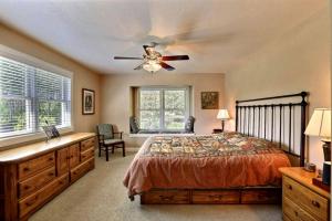 a bedroom with a bed and a ceiling fan at Four-Bedroom Luxury Vacation Rental on 80 Private Acres near Granite Peak, Wisconsin in Nutterville