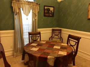 a dining room with a table and chairs and a window at Peaceful and Secluded Lake Getaway in Guntersville, Alabama in Albertville
