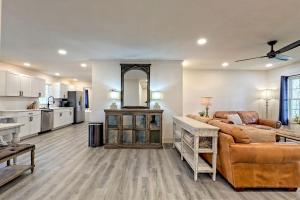 a large living room with a couch and a kitchen at Serene Cottage with Remodeled Interior and Gorgeous Pastures Views in Georgia in Shirley Grove