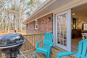a grill and two blue chairs on a porch at Serene Cottage with Remodeled Interior and Gorgeous Pastures Views in Georgia in Shirley Grove