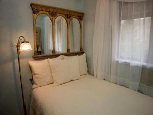 a bedroom with a mirror and a bed with pillows at Fantastic Cabin Rental Perfect for a Family Vacation to Northwest Arkansas in Ponca