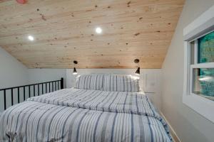 a bed in a room with a wooden ceiling at Off-grid Tree House Suitable for Four in Alabama in Grant