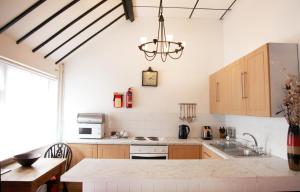 a kitchen with a sink and a counter top at Sheephouse Manor in Maidenhead