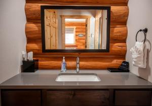 a bathroom with a sink and a mirror at Rustic-Chic Log Cabin with King Bed & Kitchen | Bonners Ferry, Idaho Retreat in Bonners Ferry +2 photos