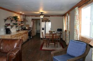 a kitchen and living room with a table and chairs at Secluded Cabin with River and Mountain Views near Columbus, Montana in Nye