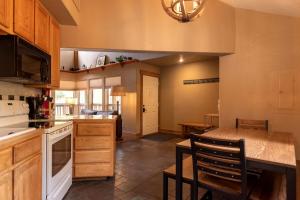 a kitchen with wooden cabinets and a counter top at Rustic Camping Cabin near the Royal Gorge in Salida, Colorado in Monarch