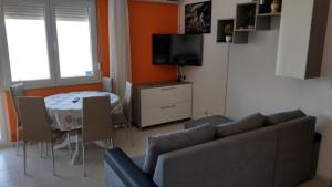 a living room with a couch and a table at Apartments Viva Ciovo in Slatine