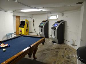 a room with a pool table and two arcade machines at Renovated luxury water tower within walking distance of the beach boulevard in Vlissingen +32 photos