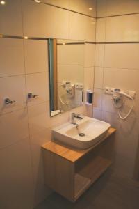 a bathroom with a sink and a mirror at Wellness hotel Sauna in Malá Morávka