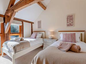 a bedroom with two beds in a attic at 3 Bed in Leominster 50513 in Pencombe