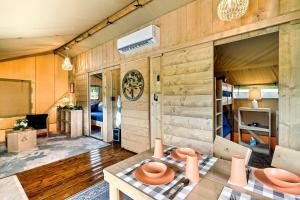 a living room with a table and chairs in a caravan at Beautiful Secluded Tented Cabin with Fire Pit in Sevierville, Tennessee in Wear Valley