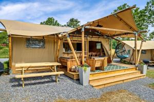 a gazebo with a table and benches in a yard at Beautiful Secluded Tented Cabin with Fire Pit in Sevierville, Tennessee in Wear Valley +37 photos