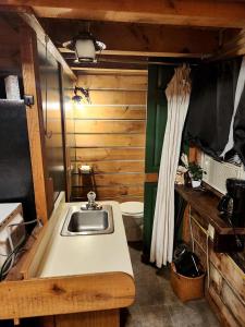 a small bathroom with a sink and a toilet at Rural Cabin with Fire Ring Perfect for Outdoor Activities in Indiana in Stony Lonesome