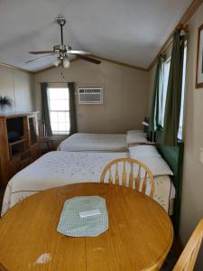 a small room with a table and two beds at Comfy Vacation Rental with Wi-Fi and Kitchenette in Meadview, Arizona in Meadview +5 photos