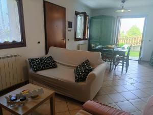 a living room with a couch and a table at Villa Bruna by Holiday World in Pisogne