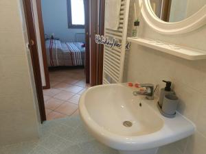 a bathroom with a white sink and a mirror at Villa Bruna by Holiday World in Pisogne +16 photos