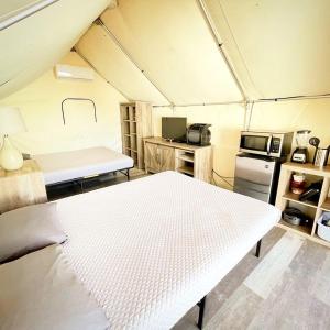 a room with a white bed in a tent at 37 Son's Marvelous Nature Escape in Kingsbury, TX in Staples