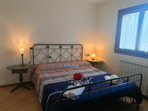 a bedroom with a bed with a red rose on it at Villa Bruna by Holiday World in Pisogne