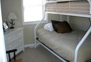 a bedroom with a bunk bed with a night stand at Charming Cottage Overlooking Gorgeous Citation Bass and Bream Pond near Charlottesville in Gordonsville