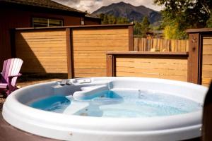a large hot tub in a yard with a chair at Weekend Getaway for Outdoor Recreation near San Isabel Forest in Colorado in Monarch