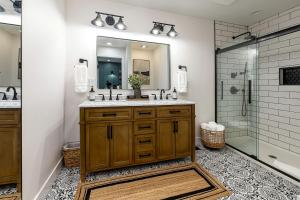 ein Badezimmer mit Waschbecken, Spiegel und Dusche in der Unterkunft Stunning Modern Cabin with Hot-tub in Makanda, illinois in Goreville + 29 Fotos