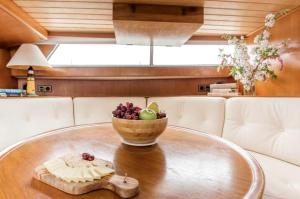 a wooden table with a bowl of fruit on it at Experience the Magic of Sleeping Your Own Private Yacht in Damariscotta, Maine in Newcastle +12 photos