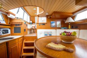 a kitchen with a bowl of fruit on a wooden table at Experience the Magic of Sleeping Your Own Private Yacht in Damariscotta, Maine in Newcastle