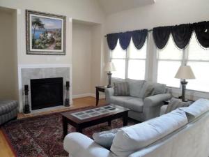 a living room with a couch and a fireplace at Elegant Lodge Rental with Lovely Countryside Views near Charlottesville, Virginia in Running Deer +6 photos