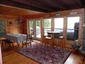 a dining room with a table and chairs in a cabin at Luxury Mountain Cabin Rental with a Hot Tub in Helen, Georgia in Helen