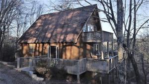 a large wooden house with a large deck at Luxury Mountain Cabin Rental with a Hot Tub in Helen, Georgia in Helen